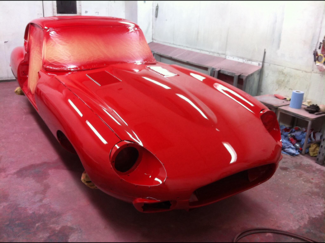 Red Jaguar E-Type in fresh paint.